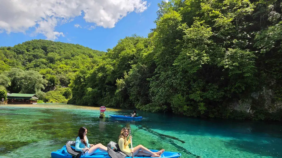 Kayaker paddling the lake below the Blue Eye Albania spring on a kayak adventure from Saranda, Vlorë County